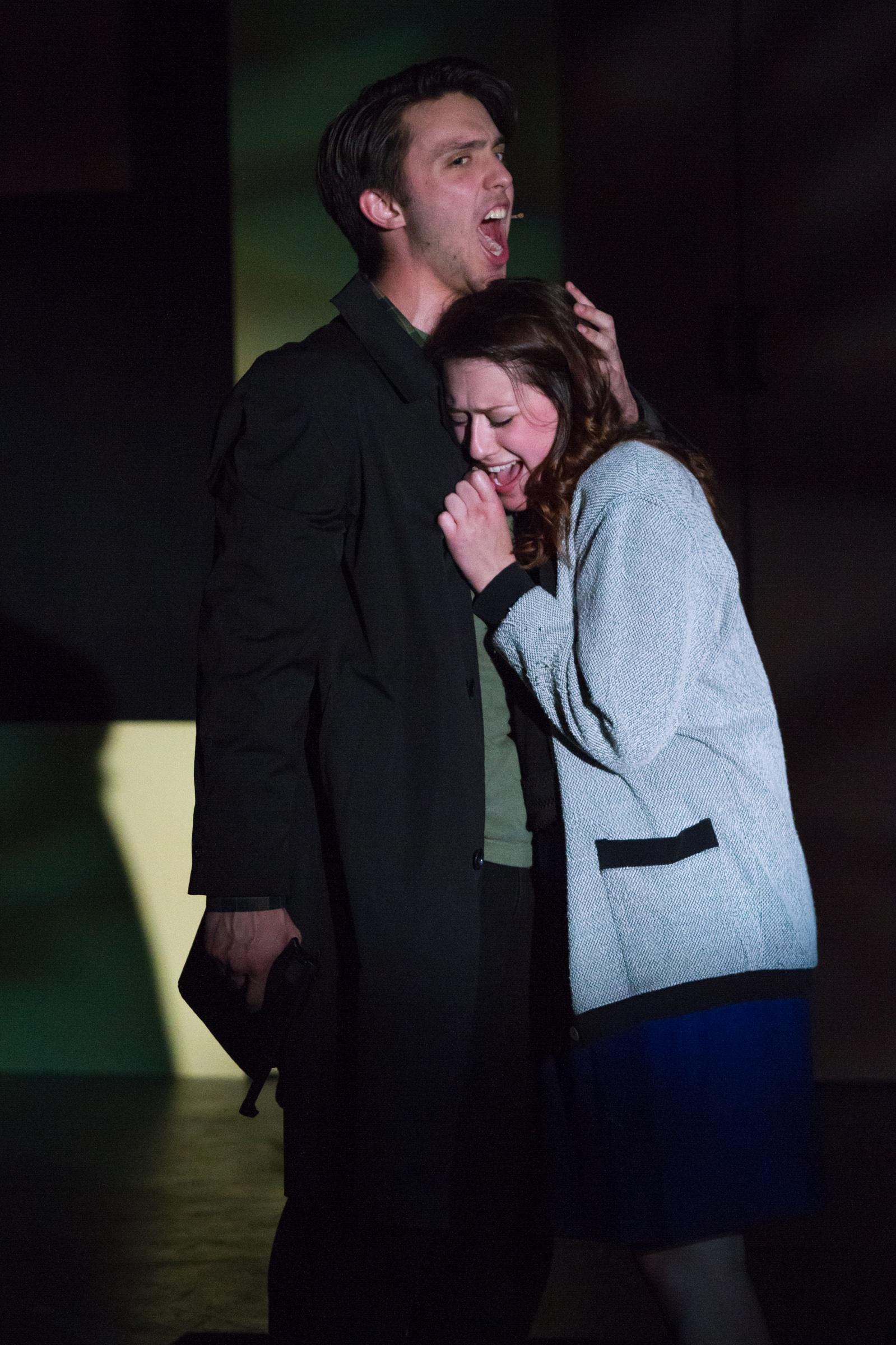 Shane Lonergan as J.D. singing behind Veronica in blue light