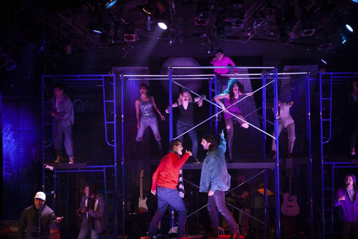 The company of Rent spread across the blue scaffolding set